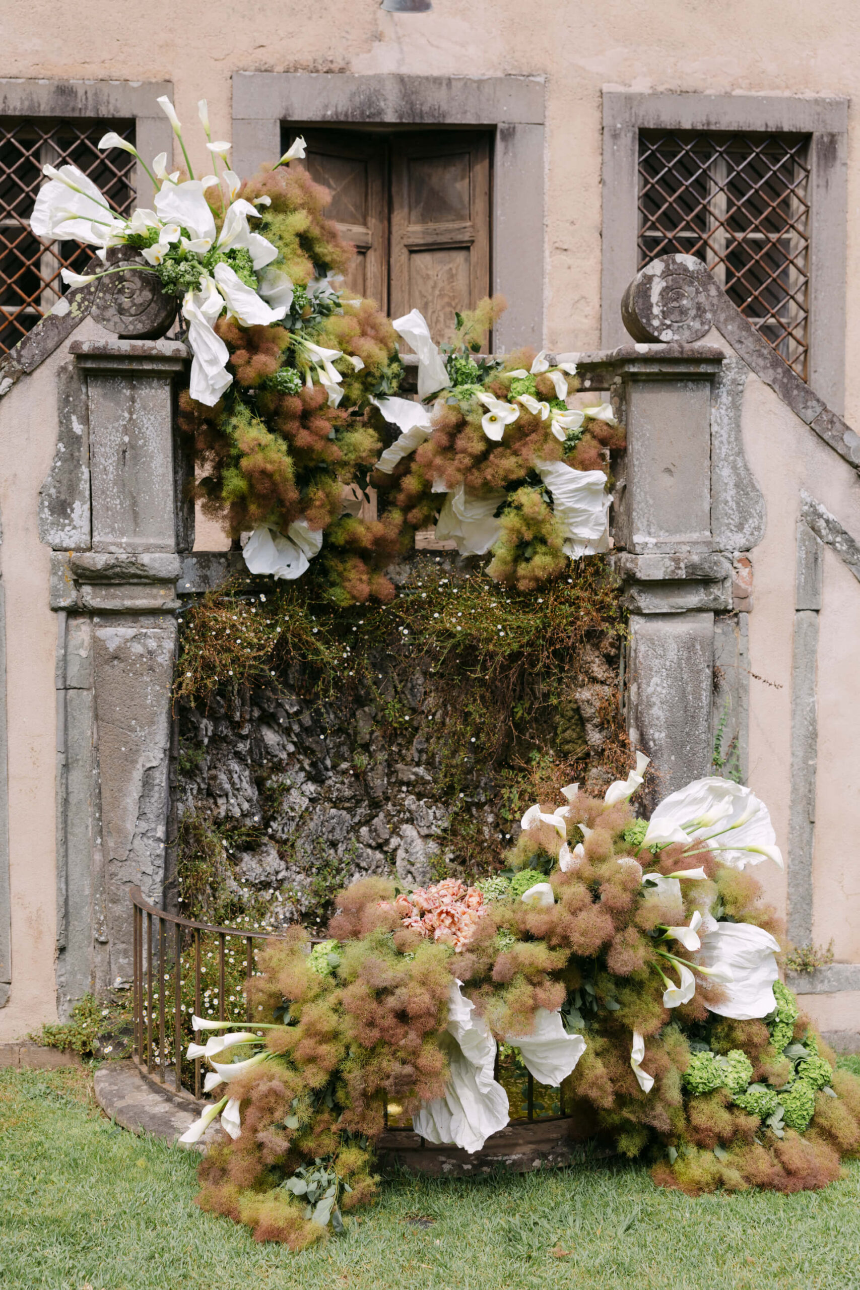 Decoración floral con calas blancas en una escalera de piedra
